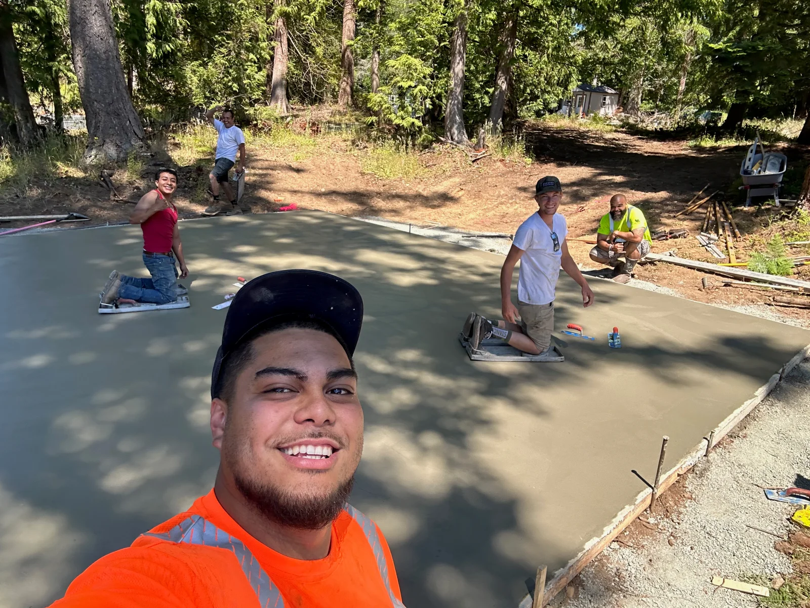 Finished concrete pad with smooth gray surface and clean edges in wooded area