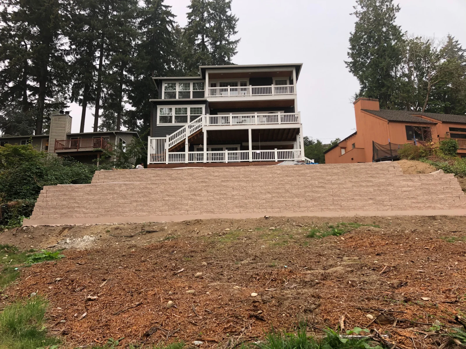 Concrete retaining block wall with stacked blocks, full-height view from base level