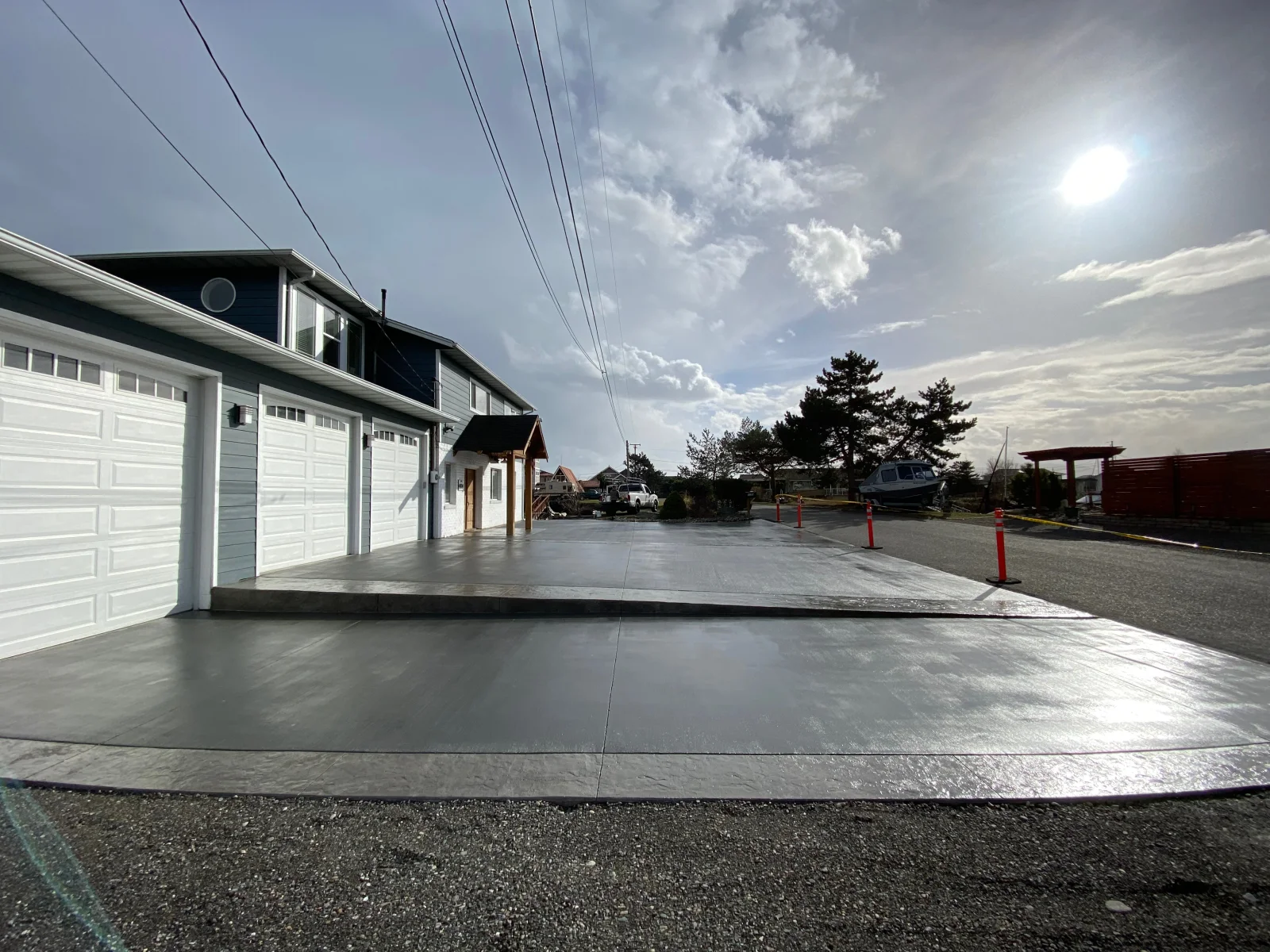 New concrete driveway with broom finish, control joints, and garage apron