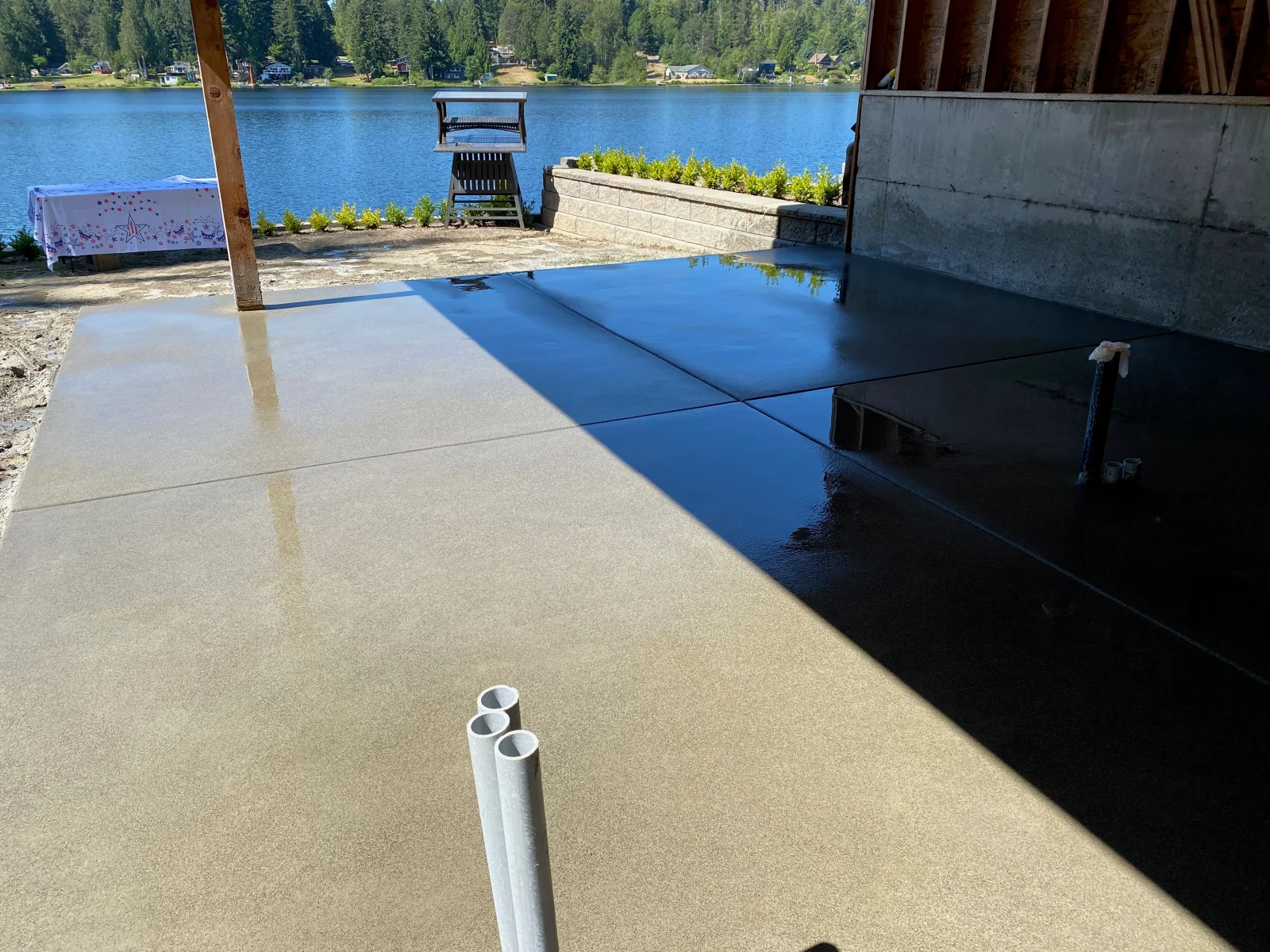 Newly poured concrete patio with sand finish and control joints, waterfront setting