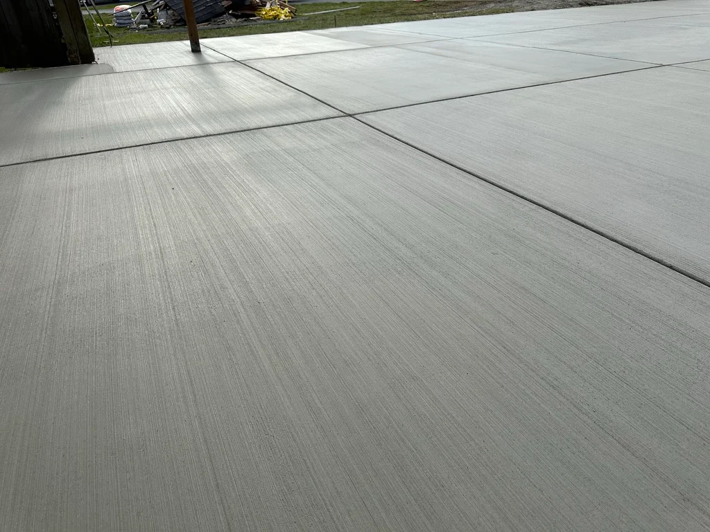 Finished concrete patio with control joints and broom finish texture