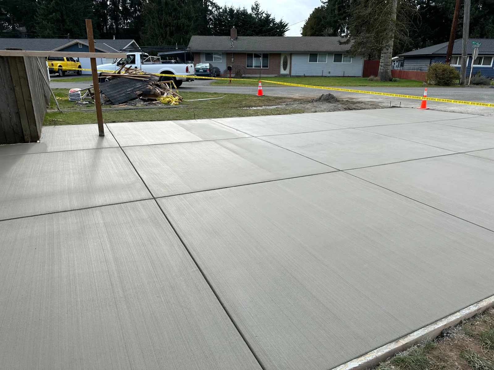 Newly poured concrete driveway with broom finish and control joints