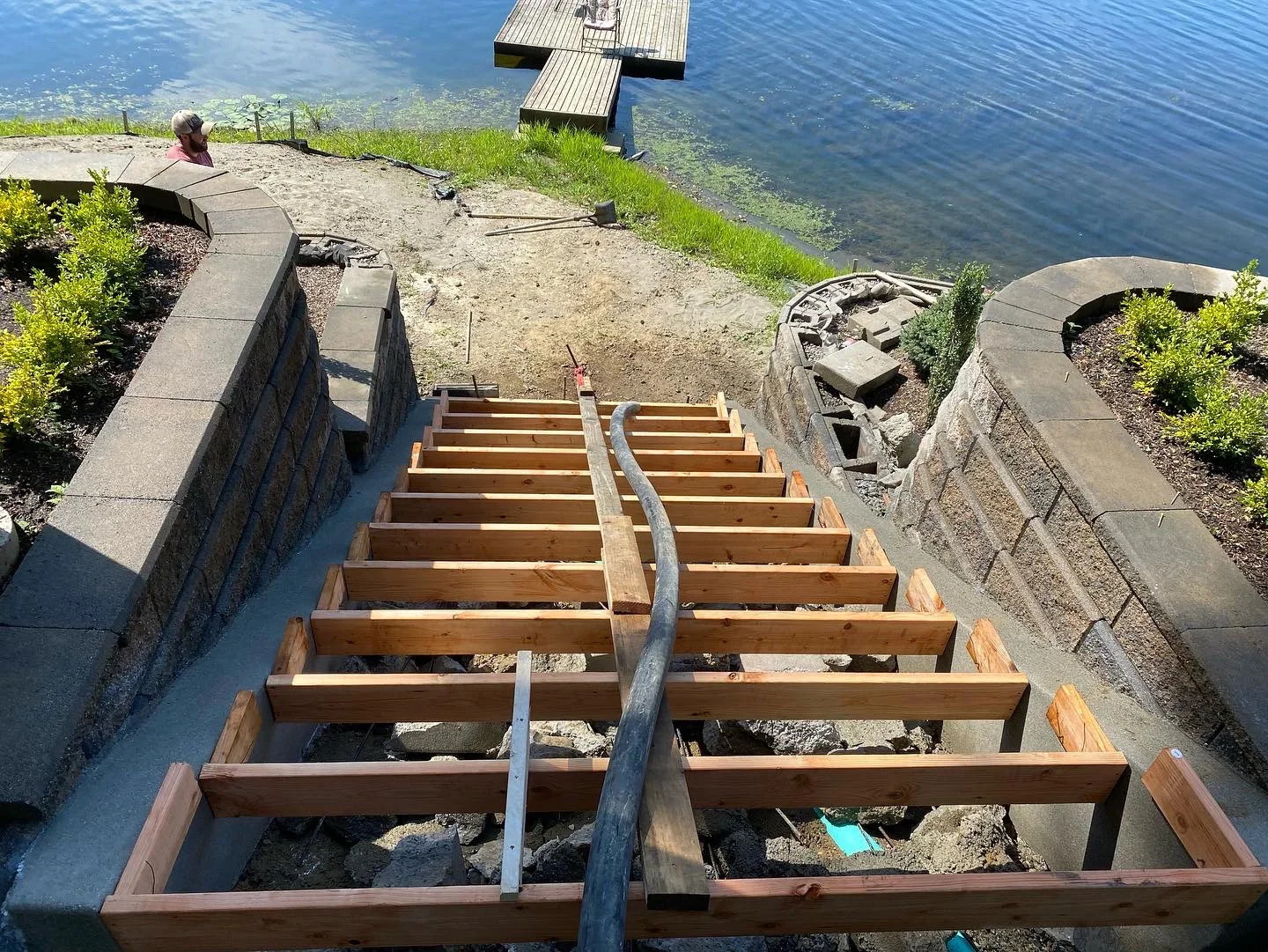 Wooden stair framing on concrete foundation with retaining walls at waterfront